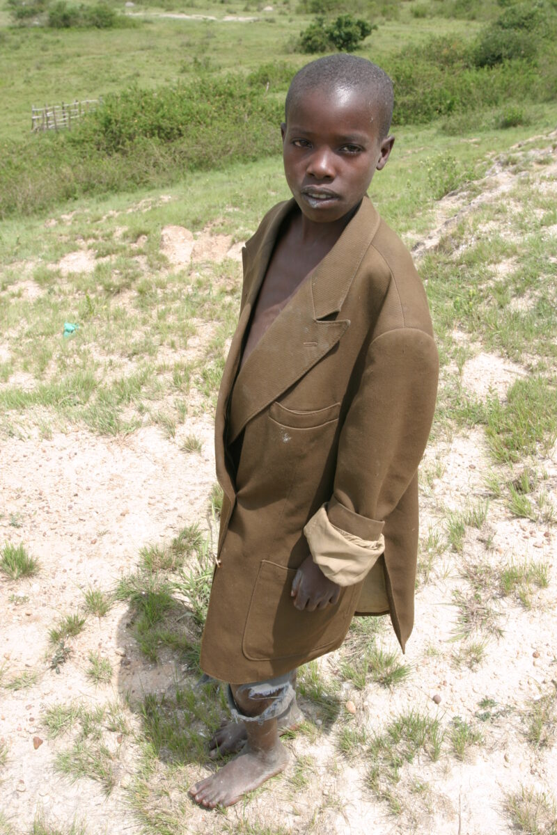 Stock Images of Rwanda — Boy spends his days herding the village cows. — Rwanda, Africa, child, Children, faces