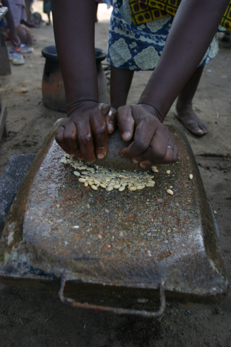 Grinding Maize on a Grinding Stone in Africa — Togo, Africa, West Africa, food, Grinding Stone