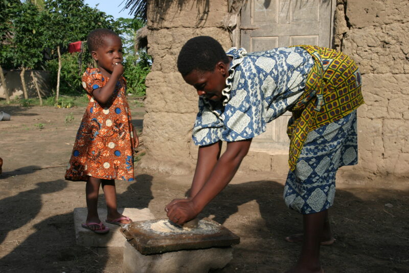 Grinding Maize on a Grinding Stone — Togo, Africa, West Africa, faces, women