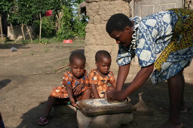 Grinding Maize on a Grinding Stone — Togo, Africa, West Africa, faces, women