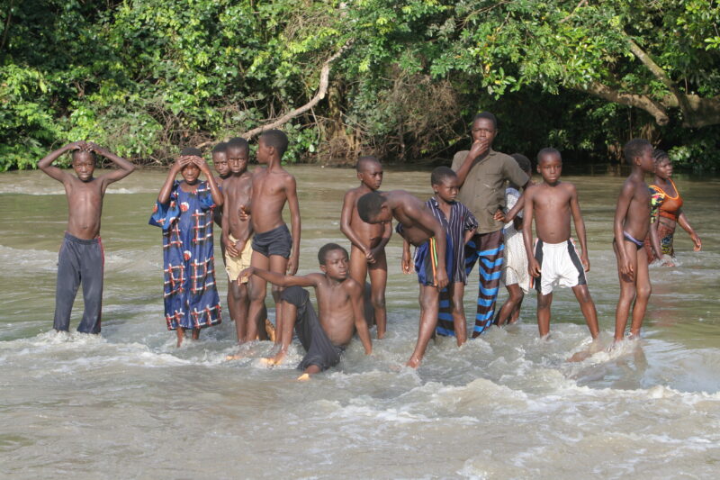 Doing Laundry in the River in Togo — Togo, Africa, West Africa, children, poor