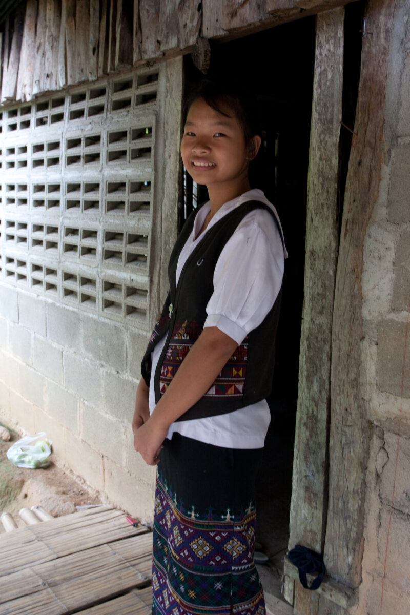 Ethnic Girl in Thailand — Young ethnic minority girl poses and smiles in the doorway of her home in Northern Thailand — Thailand, girl, smile, smiles, happy