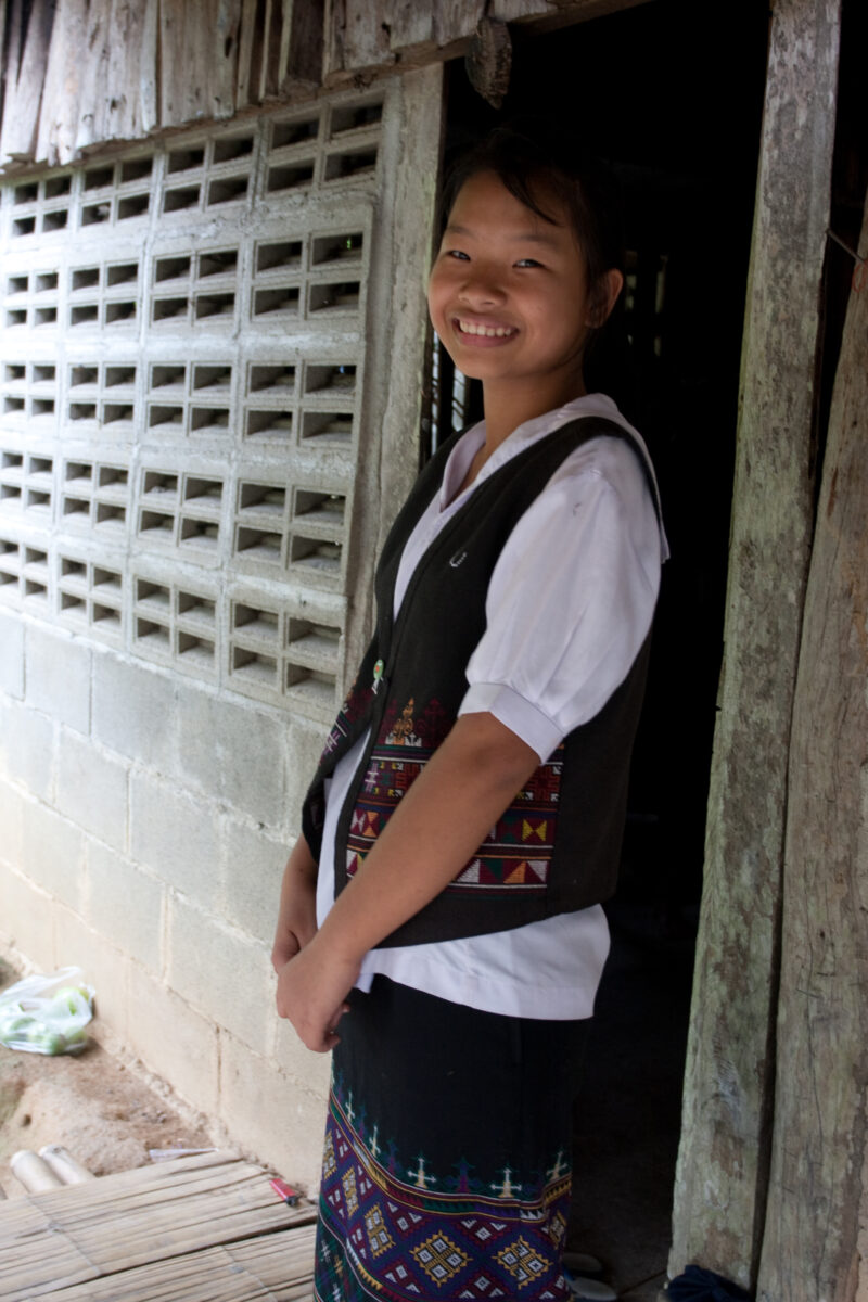Ethnic Girl in Thailand — Young ethnic minority girl poses and smiles in the doorway of her home in Northern Thailand — Thailand, girl, smile, smiles, happy