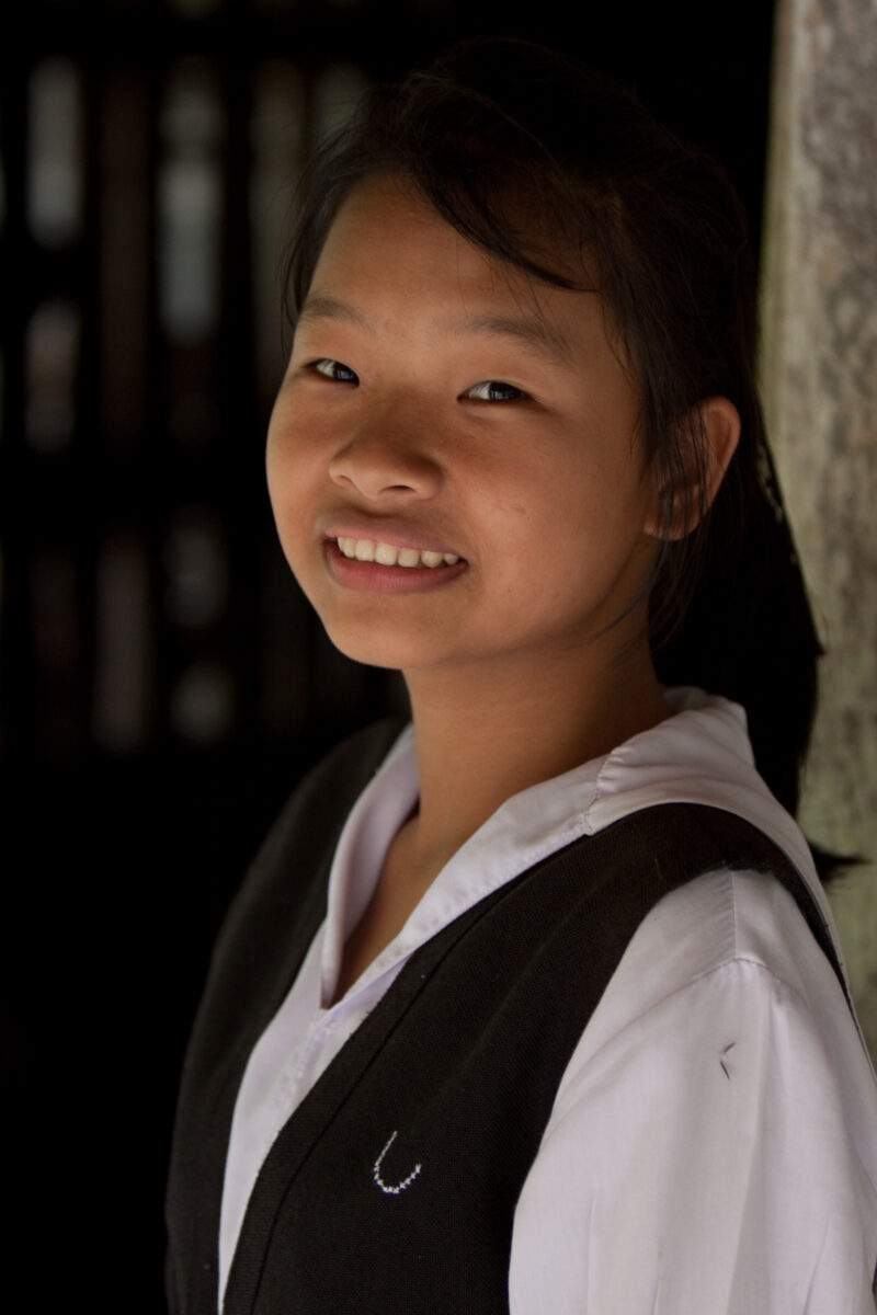 Ethnic Girl in Thailand — Young ethnic minority girl poses and smiles in the doorway of her home in Northern Thailand — Thailand, girl, smile, smiles, happy