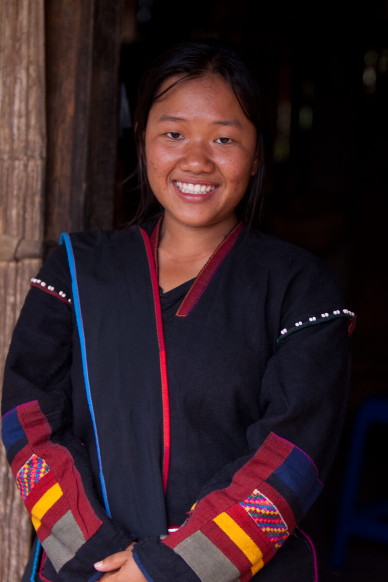 Ethnic Girl in Thailand — Ethnic minority girl in doorway of her home in Northern Thailand — Thailand, girl, ethnic minority, hill tribe, dress