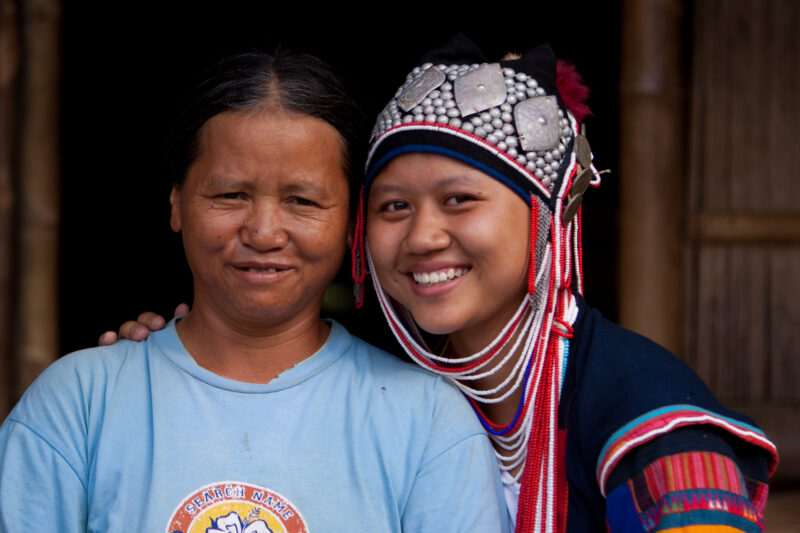 Mother and Daughter in Thailand — Girl in her ethnic dress poses with her mother by their home in Northern Thailand — Thailand, mother, daughter, ethnic