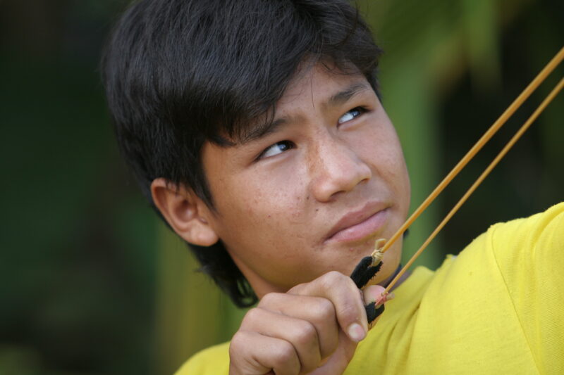 Boy with Sling Shot — Boy takes aim with his slingshot, hoping to bring down some game for the evening meal for his family in rural Thailand — Thailand, boy,...