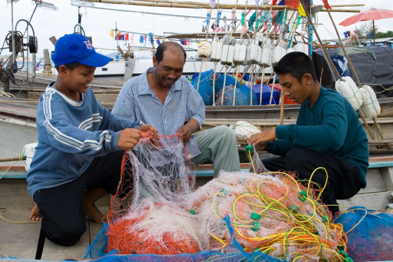 Fishing Nets in Thailand — A fisherman and his sons work with the nets near Phuket Thailand — Thailand, father, son, sons, net