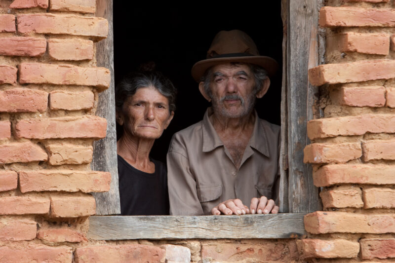 Elder Couple in Brazil — Old couple look out of the window of thier simple home in Rural Brazil. — Brazil, elders, couple, old