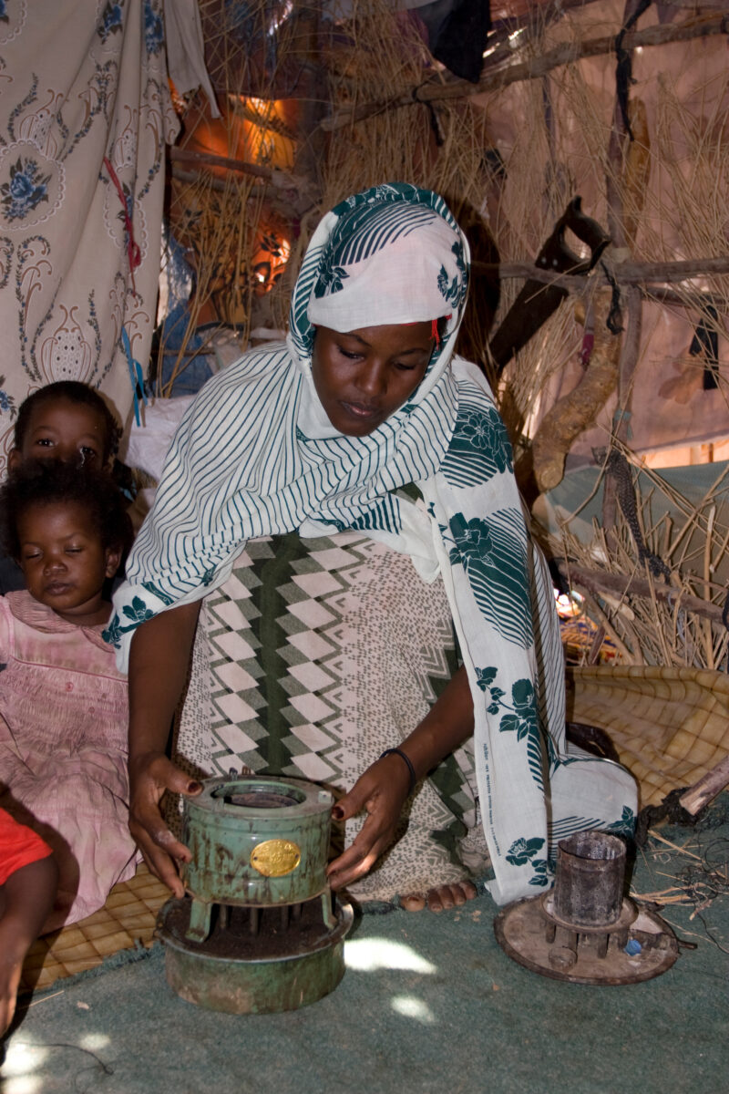 Refugee in Yemen — A refugee from Somalia begins to cook a meal for her family in the shelter she has made at the refugee Camp. — Yemen