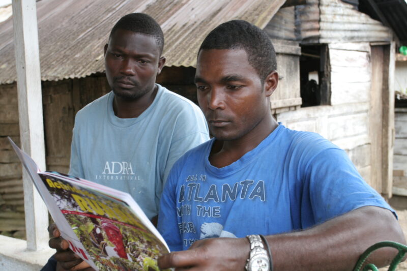 Man in Sao Tome — Man Reads health information distributed by ADRA at a health and wellness seminar — Sao Tome, Africa