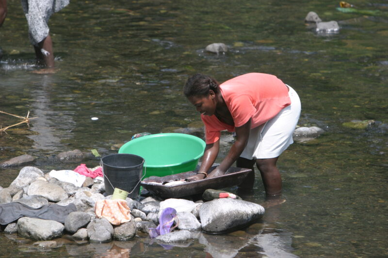 Wash Day in Sao Tome — Stock photos of women washing clothes by hand in a river near their village, in Sao Tome, Africa — Sao Tome, Africa, washing, clothes,...