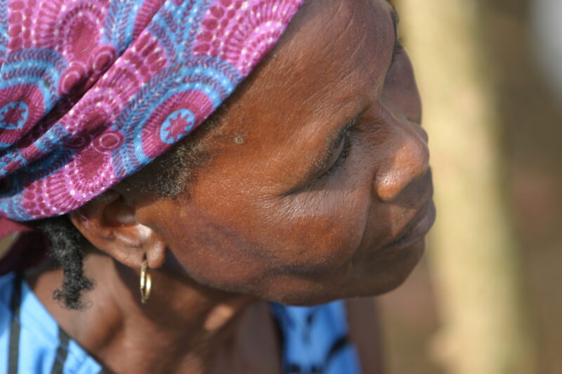 Woman in Sao Tome — Listening to a Health and Wellness seminar held in their village by ADRA — Sao Tome, Africa