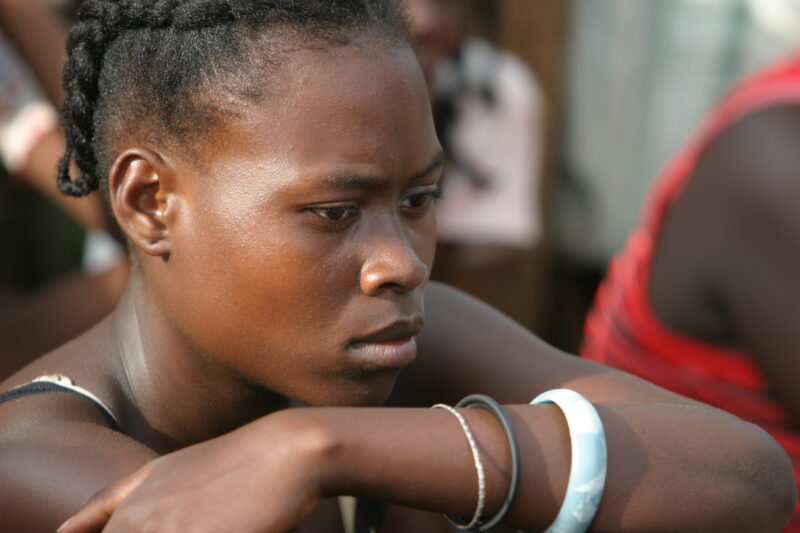 Woman in Sao Tome — Listening to a Health and Wellness seminar held in their village by ADRA — Sao Tome, Africa
