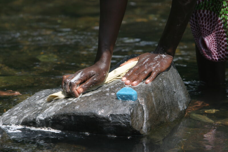 Wash Day in Sao Tome — Stock photos of women washing clothes by hand in a river near their village, in Sao Tome, Africa — Sao Tome, Africa, washing, clothes,...