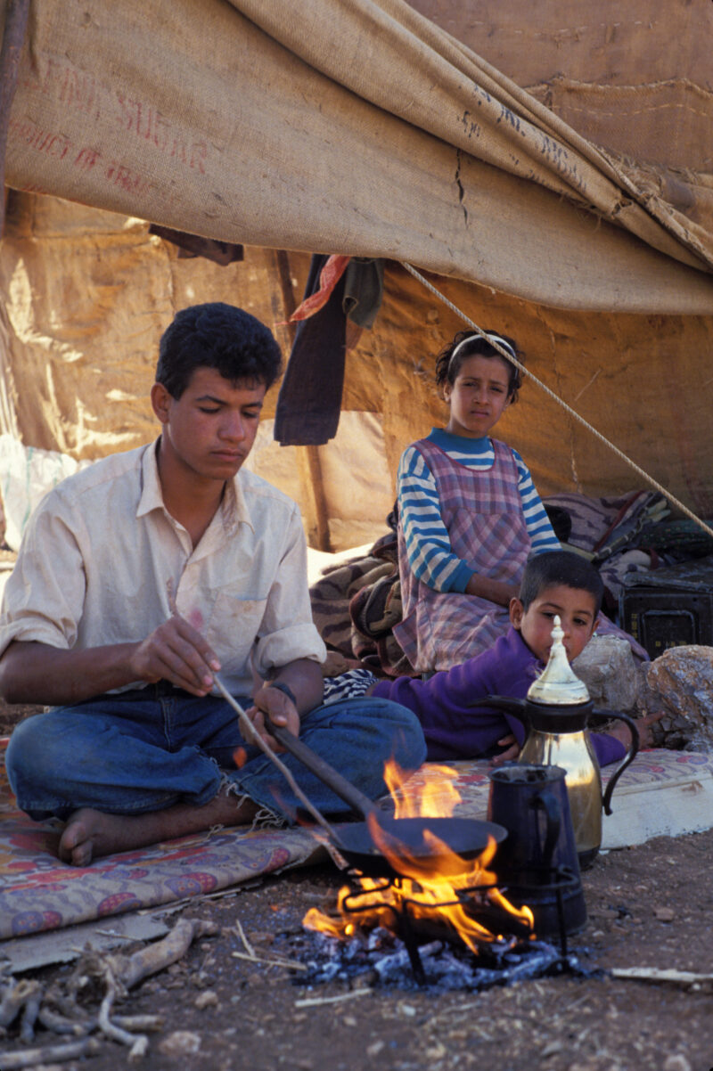 Young man Makes Coffee — Young man, part of a nomadic field working family in Jordan makes coffee for guests. — Jordan, family, tent, field workers