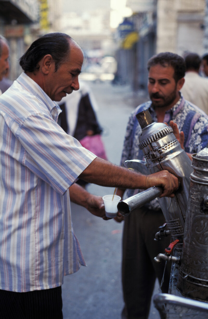 Man Serves Tea — Stock Images of the people of Jordan: Man sells tea from a moving cart on the streets of Amman Jordan — Jordan, People, men