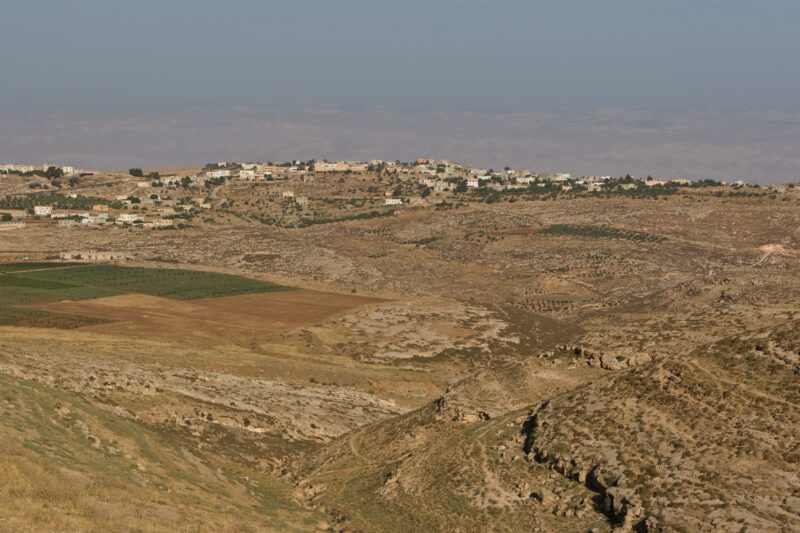 Wadi in Jordan — Typical Wadi running out into fields and more hills and villages in Jordan. — Jordan, Waddi, fields, village