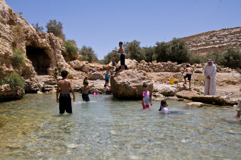 Swimming in Jordan — Children take a freshing swim in a rare pool of water that flows out of a natural spring, near Hesban — Archaeology, Jordan, pool, sprin...