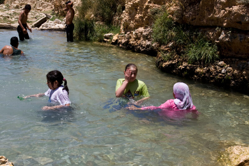Swimming in Jordan — Children take a freshing swim in a rare pool of water that flows out of a natural spring, near Hesban — Archaeology, Jordan, pool, sprin...