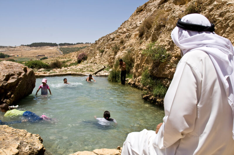 Swimming in Jordan — Children take a freshing swim in a rare pool of water that flows out of a natural spring, near Hesban — Archaeology, Jordan, pool, sprin...