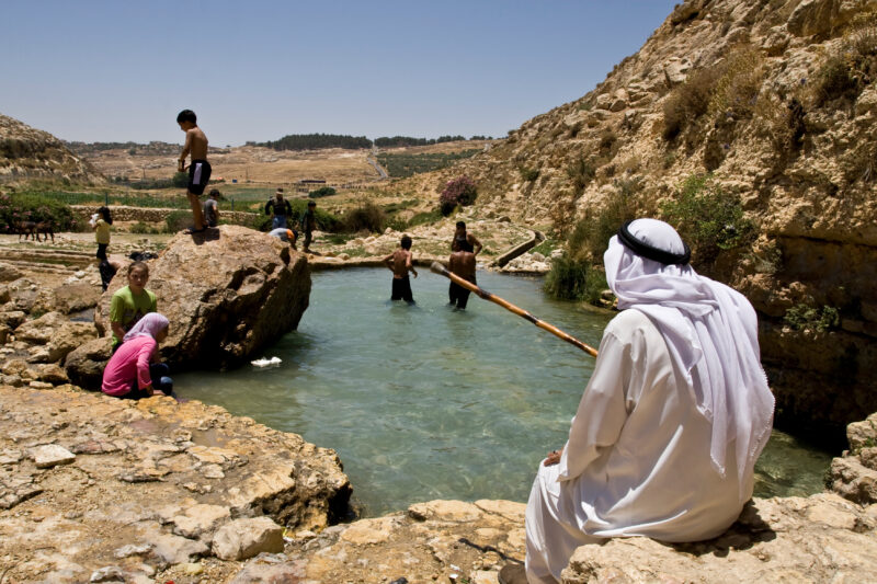 Swimming in Jordan — Children take a freshing swim in a rare pool of water that flows out of a natural spring, near Hesban — Archaeology, Jordan, pool, sprin...