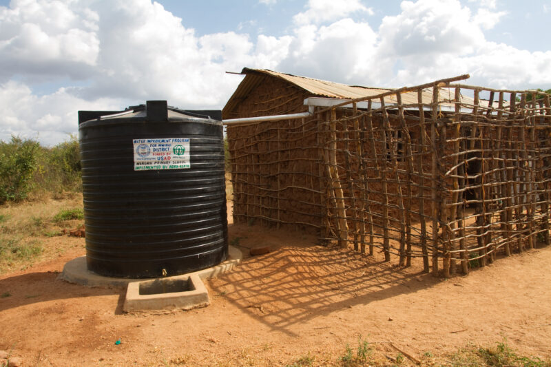 Water Stoarage Tank — In a remote rural school in Kenya, students enjoy the convenience of drinking water from a storage tank provided by ADRA, located right...
