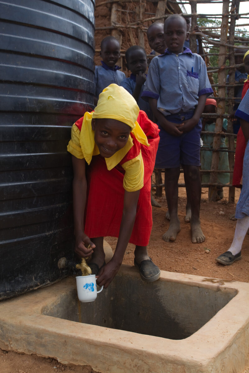 Water at School — In a remote rural school in Kenya, students enjoy the convenience of drinking water from a storage tank provided by ADRA, located right out...
