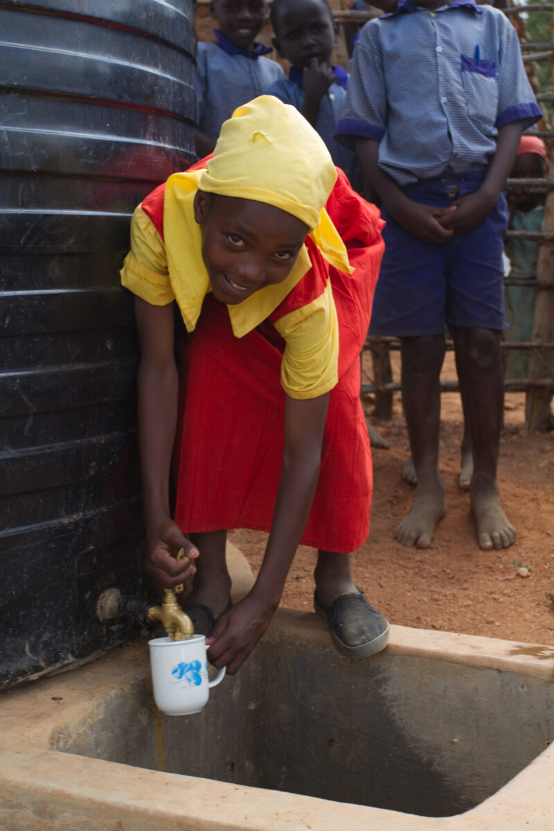 Water at School — In a remote rural school in Kenya, students enjoy the convenience of drinking water from a storage tank provided by ADRA, located right out...