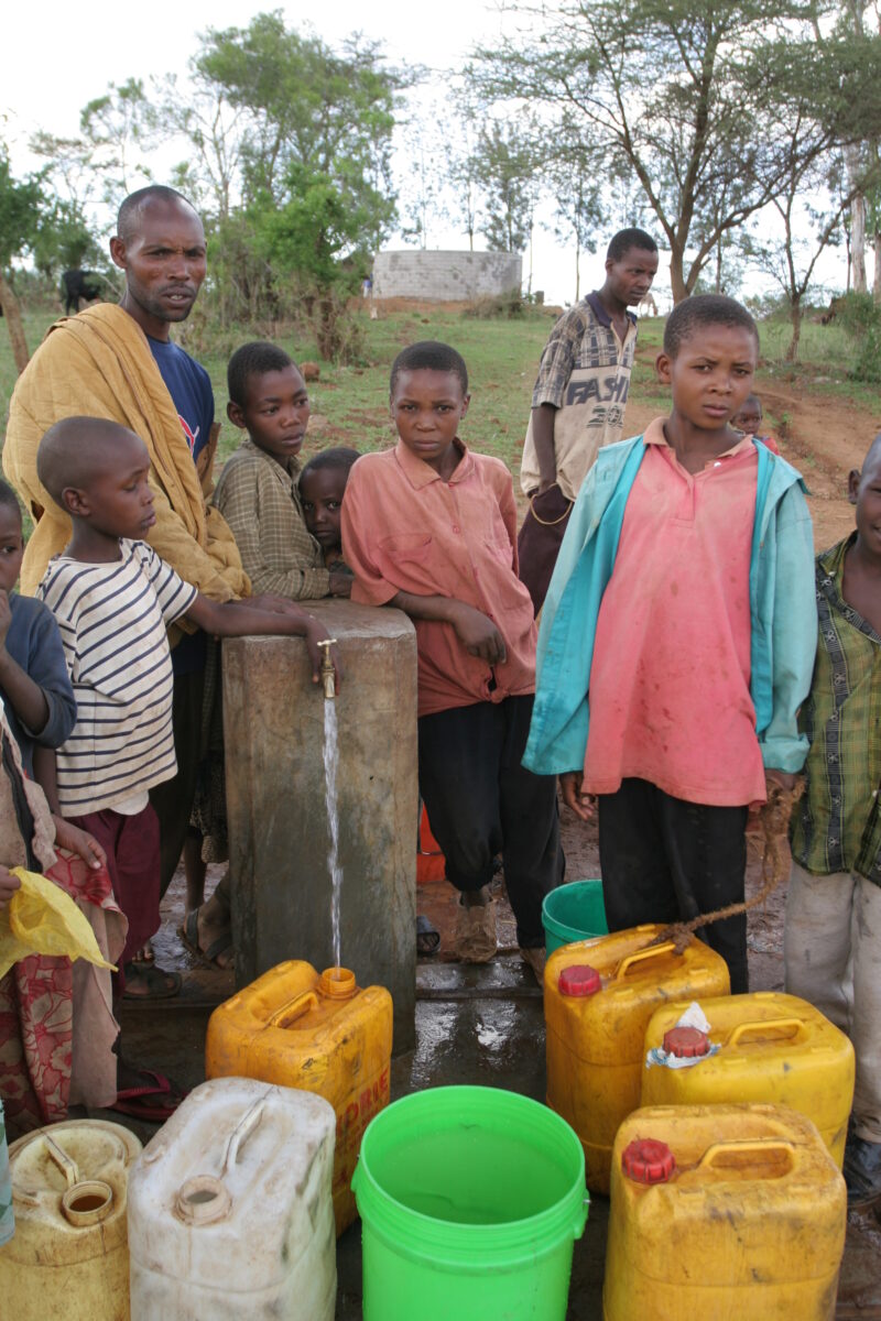 At the Water Tap in Tanzania — People living in Hanang District of Tanzania, now enjoy an extensive, gravity fed water system that brings water from mountain...