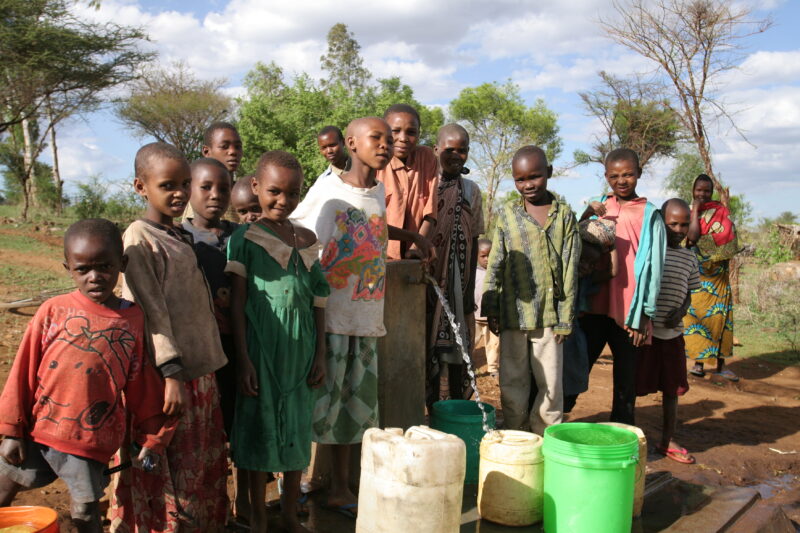 At the Water Tap in Tanzania — People living in Hanang District of Tanzania, now enjoy an extensive, gravity fed water system that brings water from mountain...