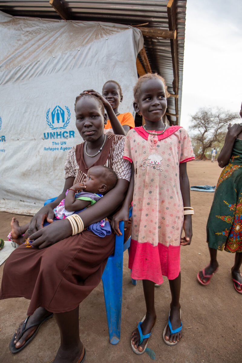 Arriving in Uganda — After fleeing their homeland, refugees arrive in Uganda. — Adult, Boat, Child, Eyes Open, Female