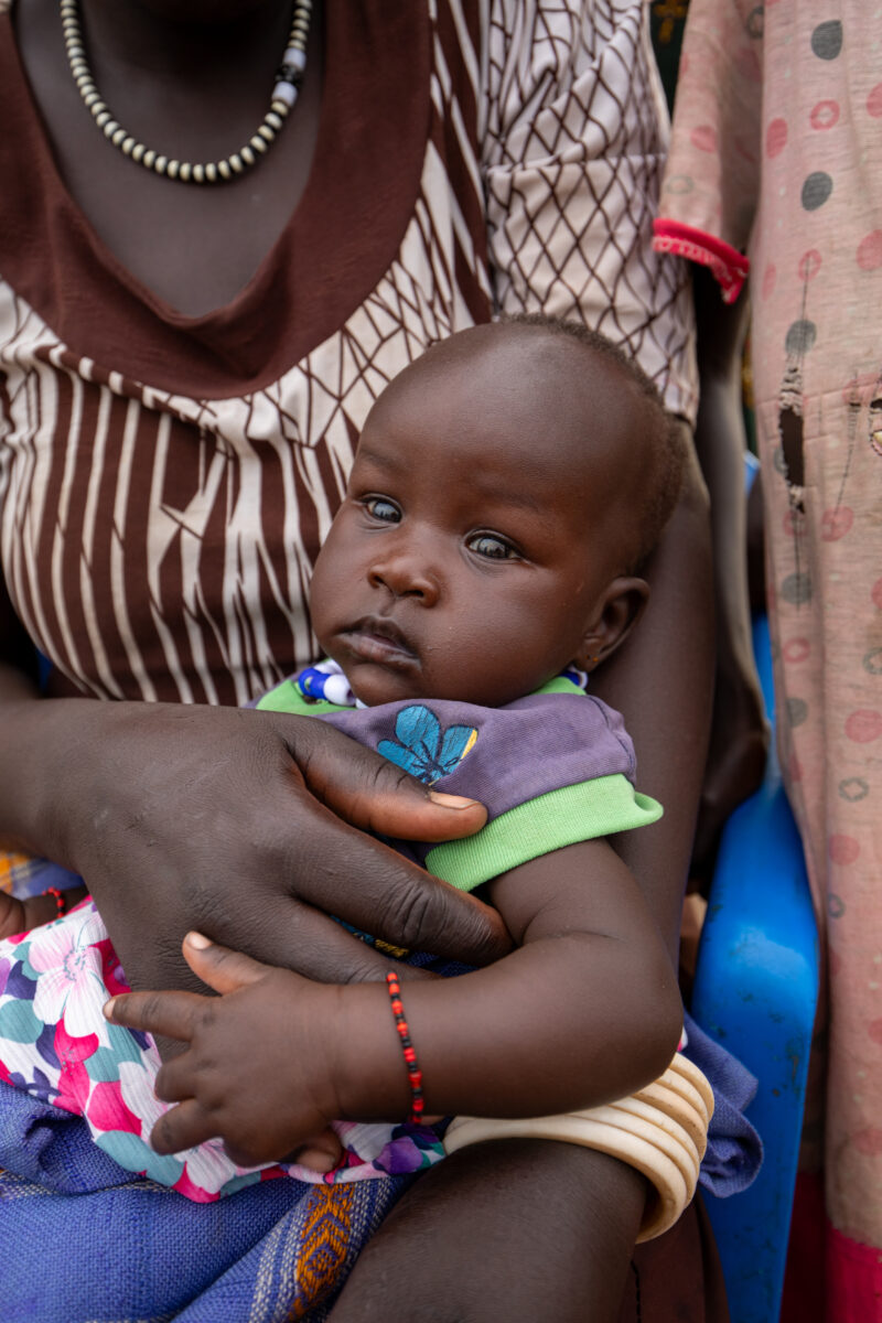 Arriving in Uganda — After fleeing their homeland, refugees arrive in Uganda. — Baby, Eyes Open, Frontal Face, One Face, Person