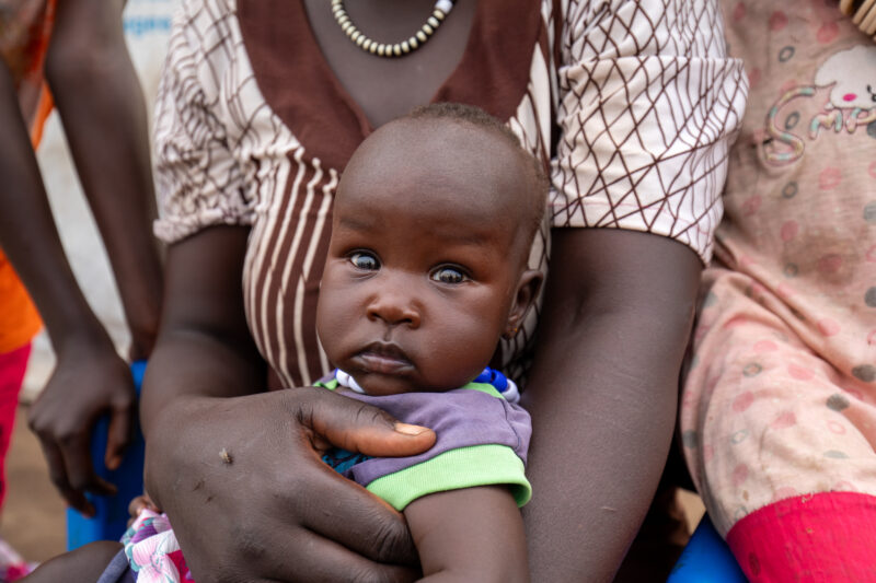 Arriving in Uganda — After fleeing their homeland, refugees arrive in Uganda. — Baby, Eyes Open, Frontal Face, One Face, Person