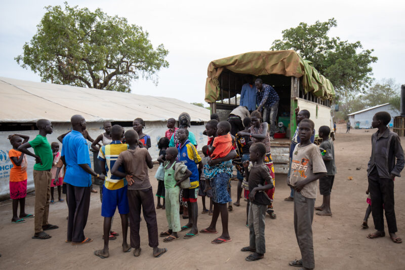 Arriving in Uganda — After fleeing their homeland, refugees arrive in Uganda. — Adult, Architecture, Child, Eyes Open, Female