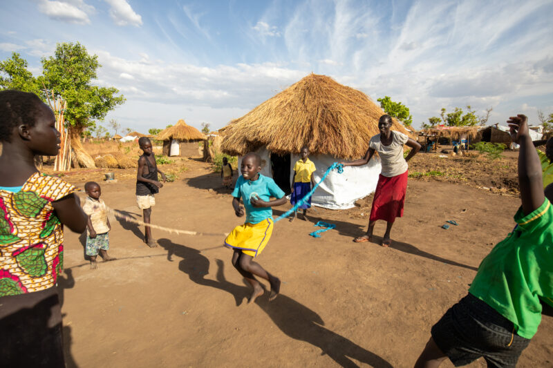 Skipping in a Refugee Settlement — Refugee kids from South Sudan, play games in their new home in Uganda. — Ball Game, Child, Eyes Closed, Eyes Open, Female