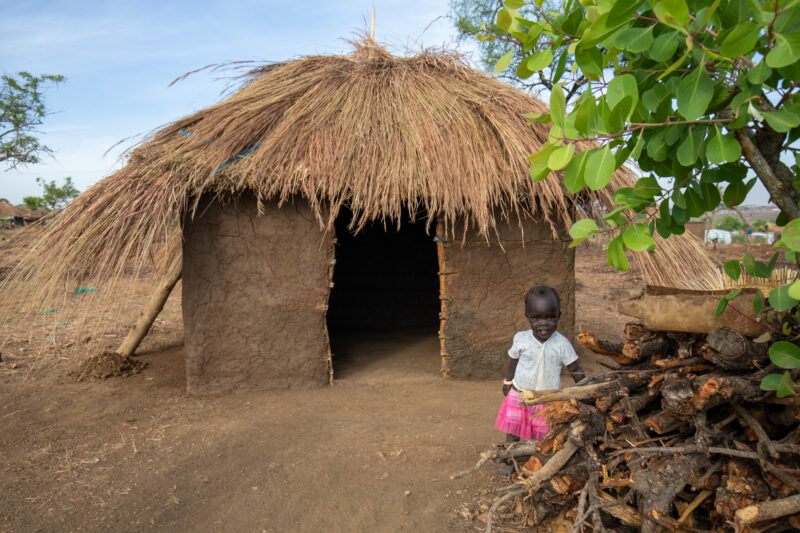 Refugee Housing — Refugees from South Sudan given a small plot of land in their host country of Uganda to build a small house. — Child, Eyes Open, Frontal Fa...