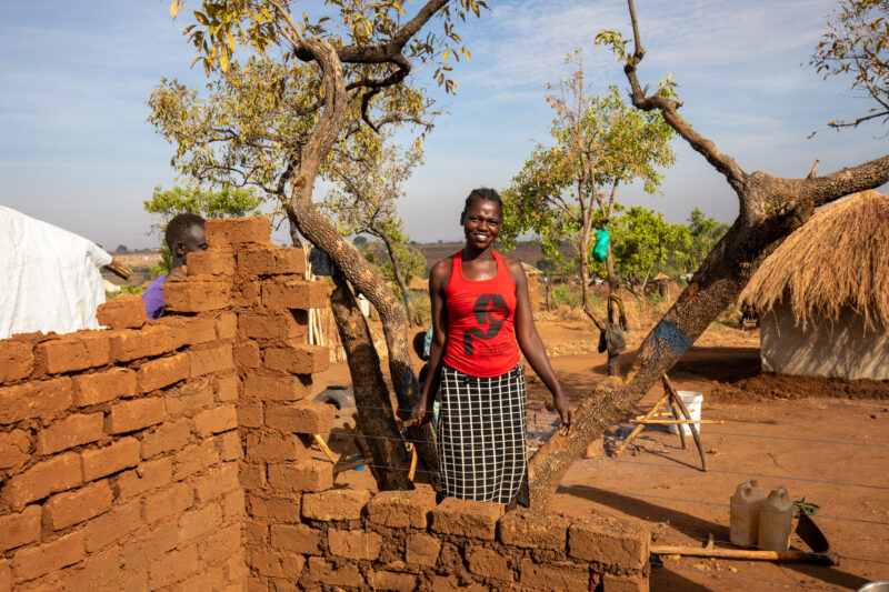 Building a House — Refugees from South Sudan build a small house in the Refugee Settlement that have been invited to by Uganda. — Eyes Open, Frontal Face, Ma...