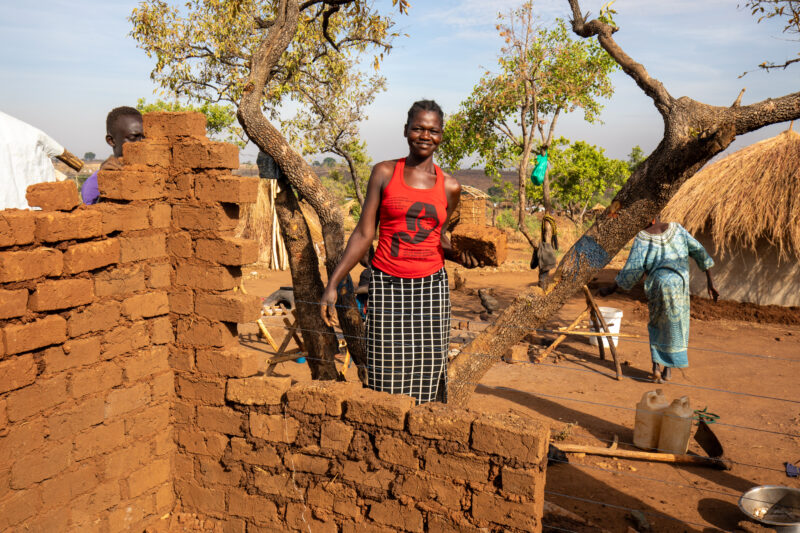 Building a House — Refugees from South Sudan build a small house in the Refugee Settlement that have been invited to by Uganda. — Eyes Open, Frontal Face, Ma...