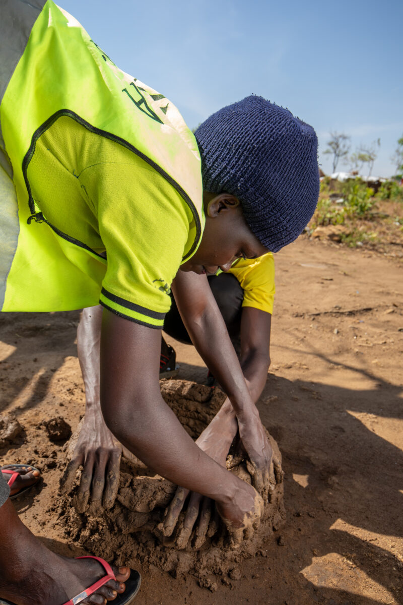 Making a Stove from Mud — Volunteers make a cooking Stove from mud — Refugee, Refugee Settlement, South Sudan