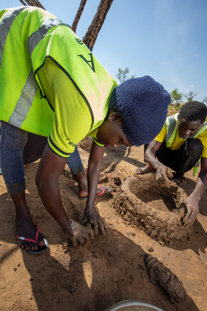 Making a Stove from Mud — Volunteers make a cooking Stove from mud — Athletics, One Face, Person, Portrait, Profile Face