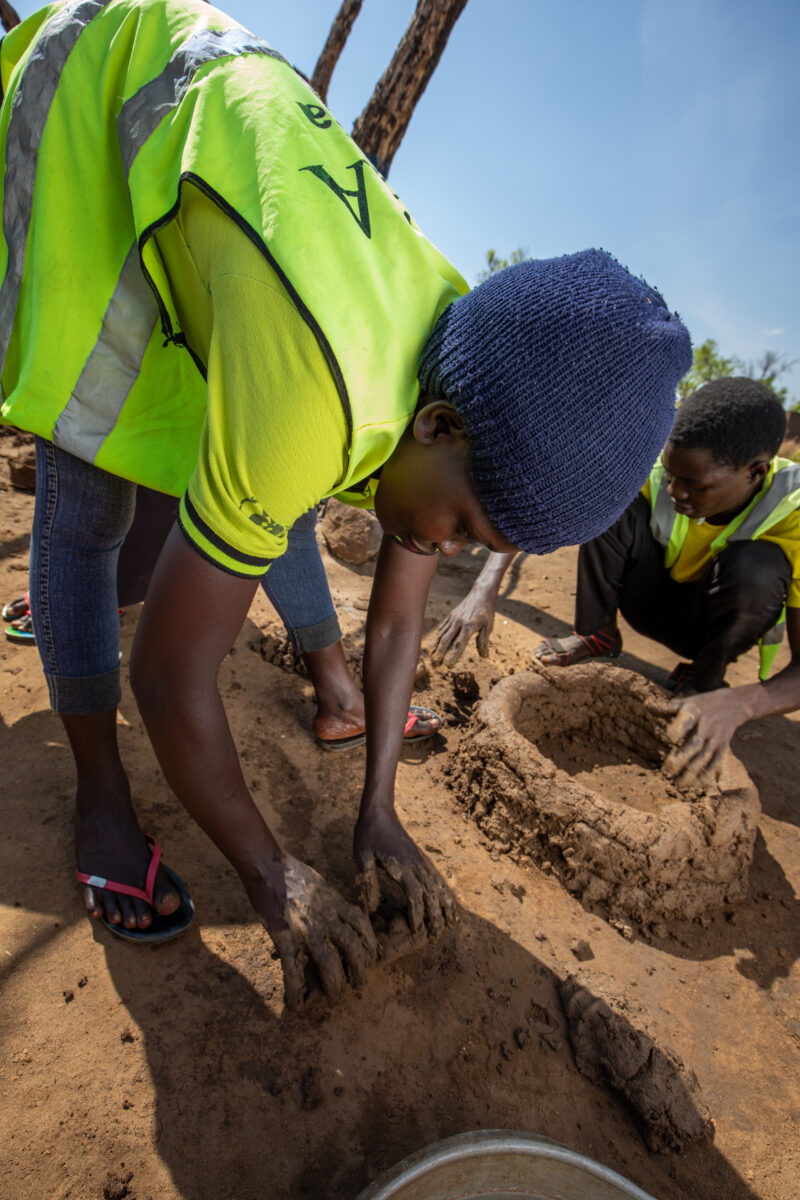 Making a Stove from Mud — Volunteers make a cooking Stove from mud — Refugee, Refugee Settlement, South Sudan