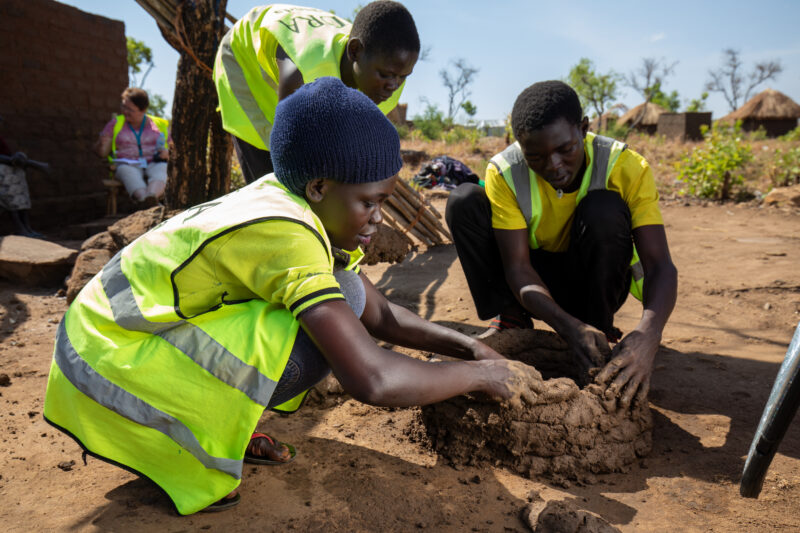 Making a Stove from Mud — Volunteers make a cooking Stove from mud — Adult, Eyes Closed, Frontal Face, Male, Person