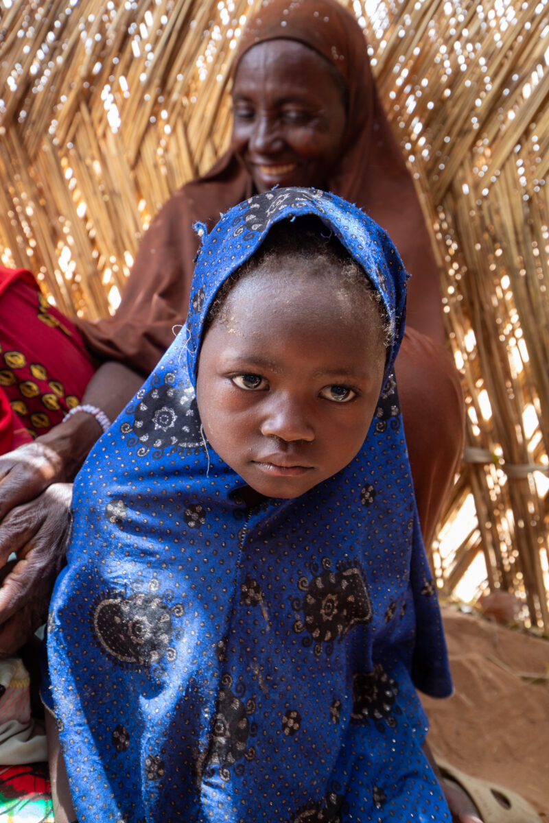 Temporary Classroom — Students in Niger, Africa, attend school in a classroom made of mud and sticks. — Adult, Africa, Beard, Child, Complementary Colors