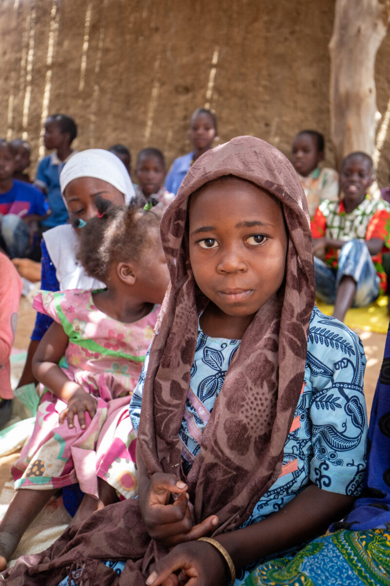 Temporary Classroom — Students in Niger, Africa, attend school in a classroom made of mud and sticks. — Africa, Child, Education, Eyes Open, Female