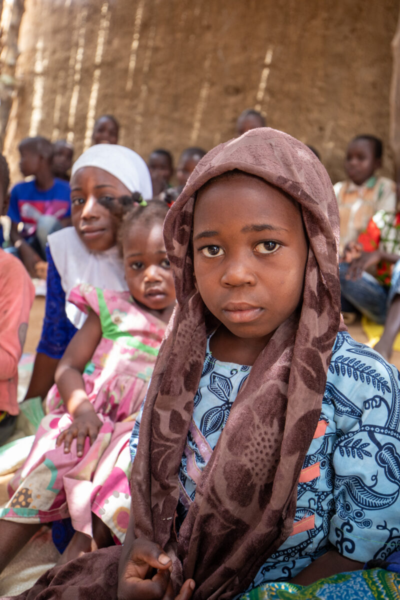 Temporary Classroom — Students in Niger, Africa, attend school in a classroom made of mud and sticks. — Adult, Africa, Education, Eyes Closed, Eyes Open