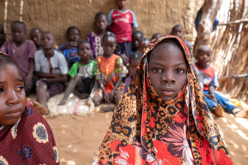 Temporary Classroom — Students in Niger, Africa, attend school in a classroom made of mud and sticks. — Adult, Africa, Beard, Child, Education