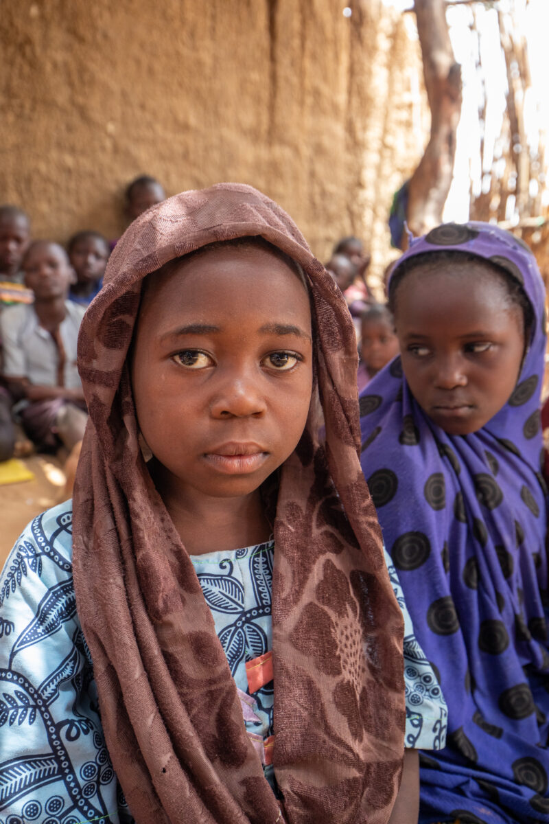 Temporary Classroom — Students in Niger, Africa, attend school in a classroom made of mud and sticks. — Africa, Child, Education, Eyes Open, Female