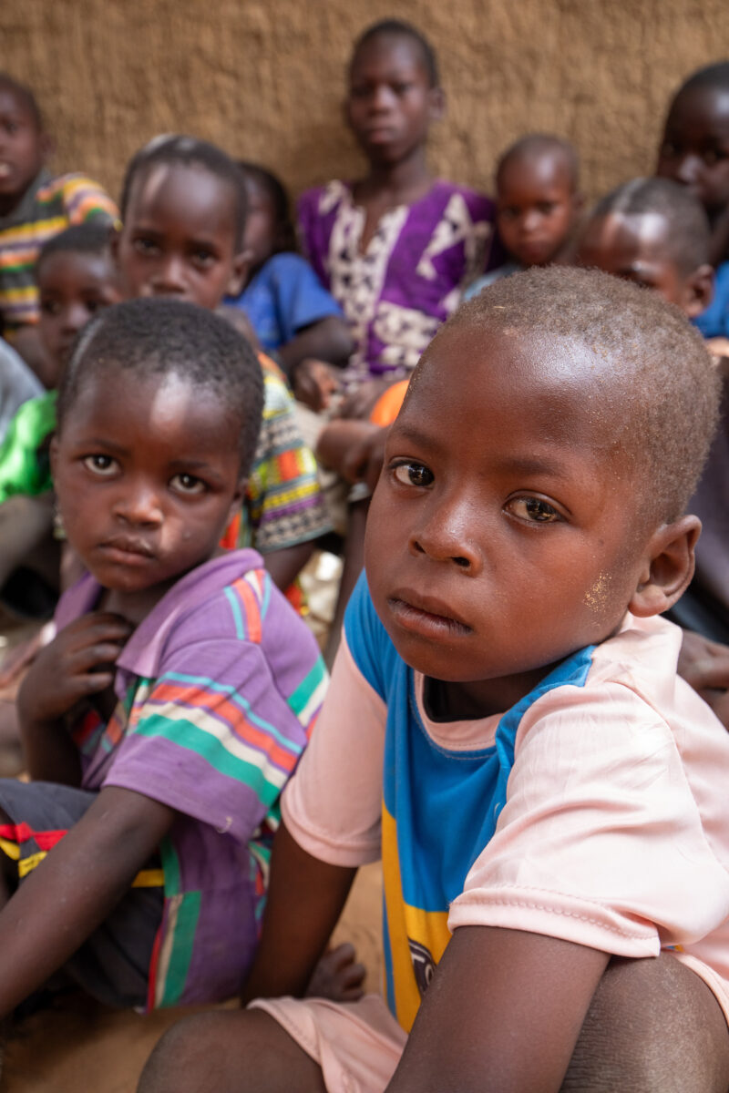Temporary Classroom — Students in Niger, Africa, attend school in a classroom made of mud and sticks. — Adult, Africa, Child, Education, Eyes Open