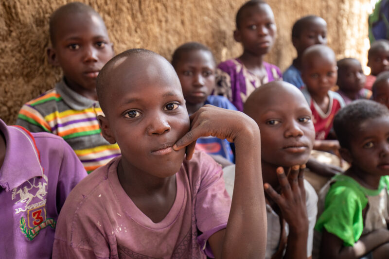 Temporary Classroom — Students in Niger, Africa, attend school in a classroom made of mud and sticks. — Africa, Child, Education, Eyes Closed, Eyes Open